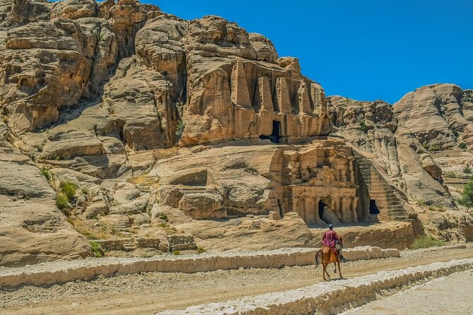 Petra 1-Day Tour from Jerusalem with FREE Authentic Lunch - Walking through Petra’s red-rock entrance